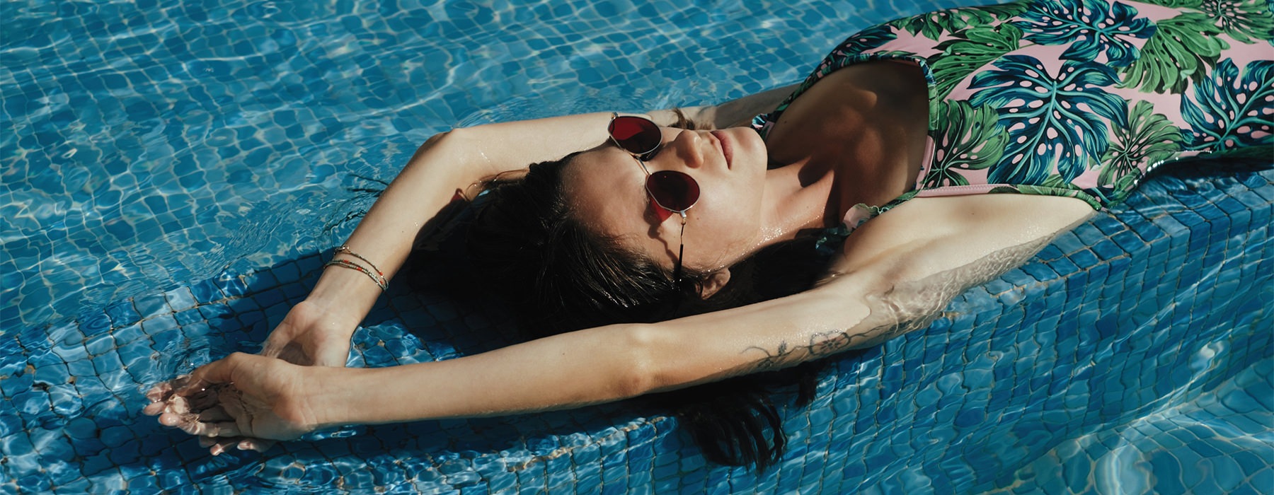 Lifestyle photo of a woman swimming in the pool