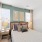 Modern furnishings in the model apartment bedroom at The Finch