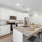 Modern apartment kitchen with large island in model home at The Finch