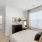 Queen sized bed in carpeted bedrooms in the model apartment at The Finch